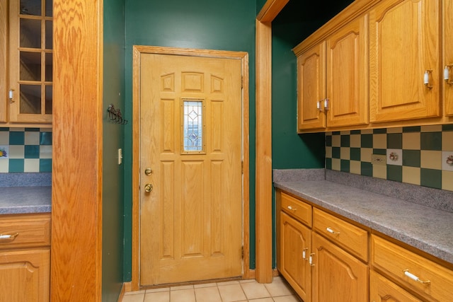 kitchen featuring light tile patterned floors and tasteful backsplash