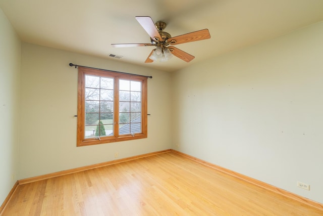 spare room featuring light hardwood / wood-style floors and ceiling fan