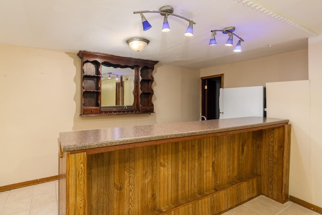 interior space featuring white fridge and light tile patterned flooring