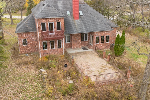 rear view of property featuring a patio area