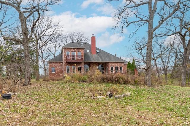 back of house with a lawn