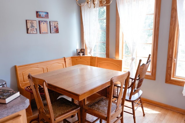 dining room featuring a notable chandelier and light wood-type flooring