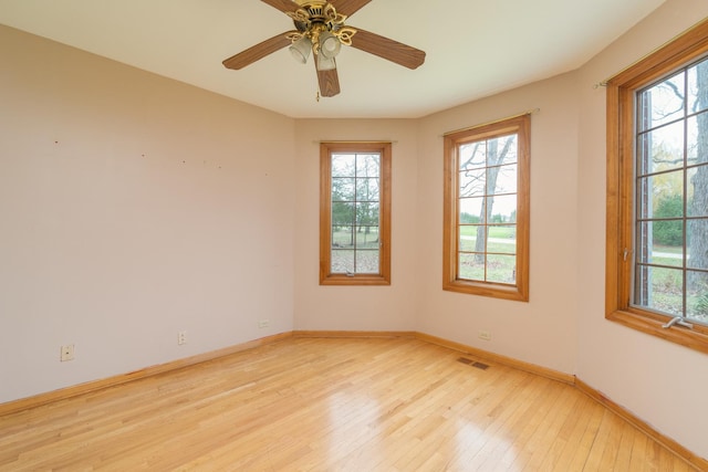 unfurnished room with ceiling fan and light hardwood / wood-style flooring