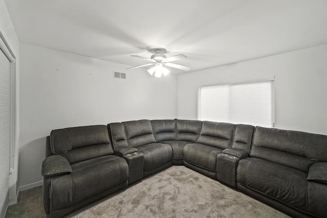 carpeted living room with ceiling fan