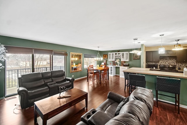 living room featuring dark hardwood / wood-style flooring and ceiling fan