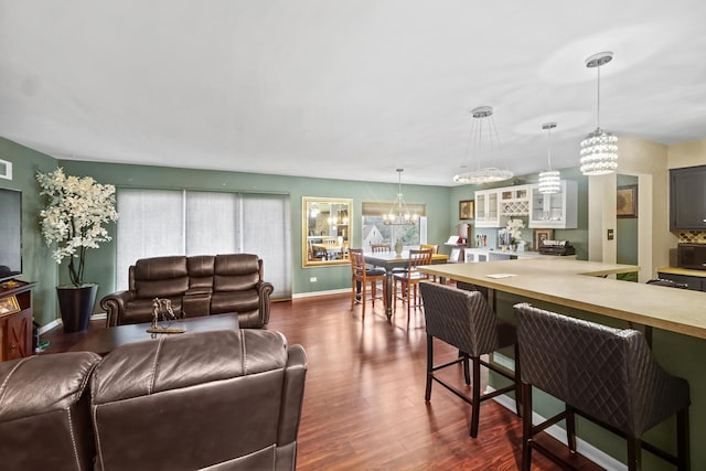 living room featuring a notable chandelier and dark hardwood / wood-style flooring