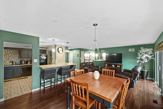 dining area featuring a fireplace, dark hardwood / wood-style floors, and sink