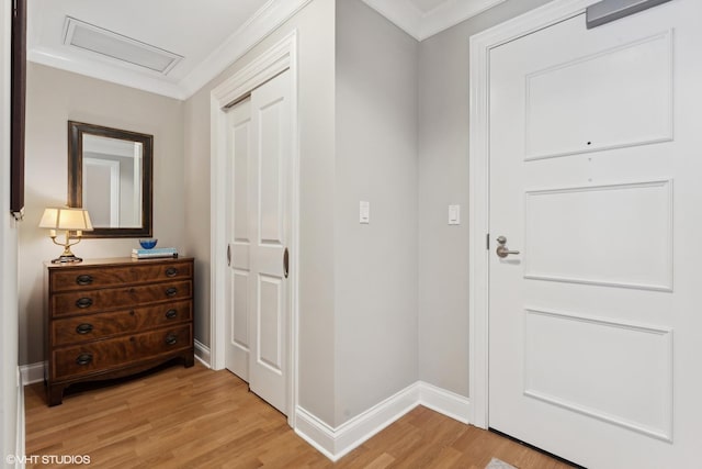 interior space with ornamental molding and light hardwood / wood-style flooring