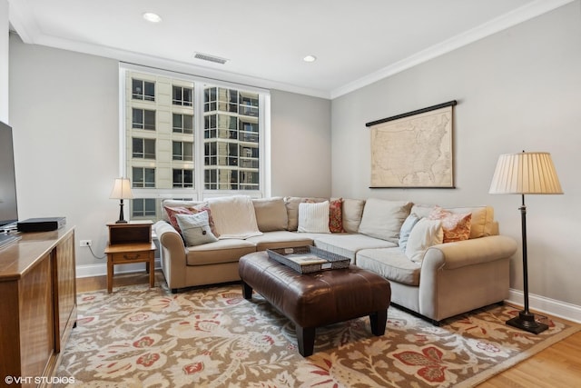 living room with light wood-type flooring and ornamental molding