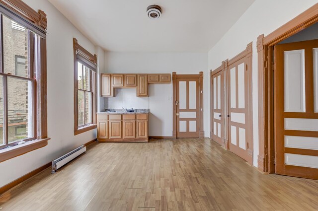 1351 N Campbell Ave, Chicago, IL 60622 - kitchen featuring a baseboard heating unit, light wood-style floors, and light countertops