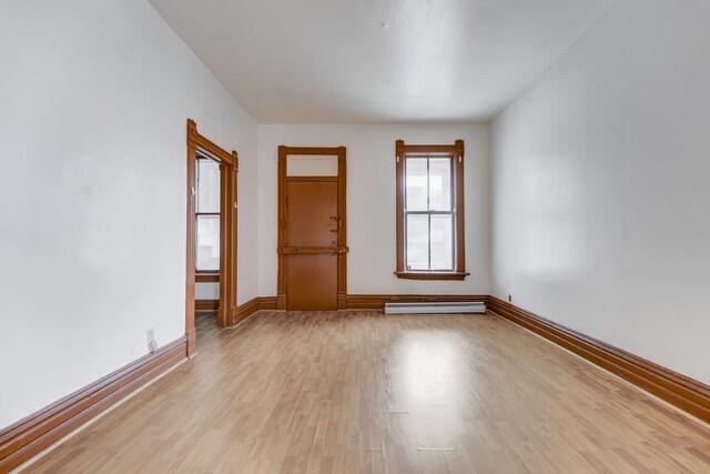 1351 N Campbell Ave, Chicago, IL 60622 - empty room featuring baseboard heating, light wood-style floors, and baseboards