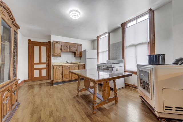 1351 N Campbell Ave, Chicago, IL 60622 - kitchen with white appliances, a sink, light countertops, backsplash, and light wood-style floors
