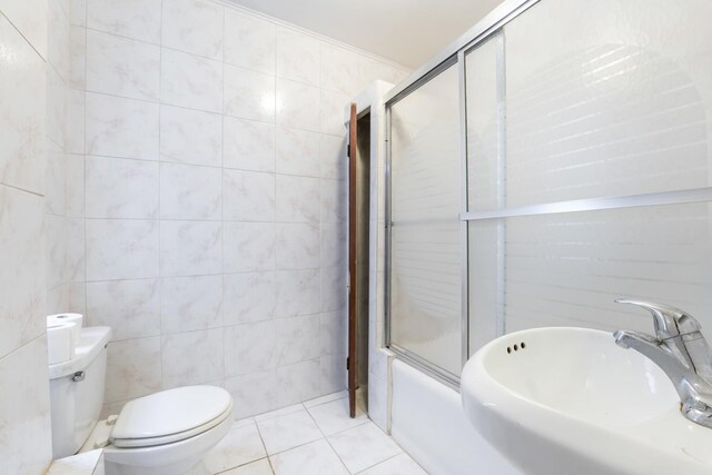 1351 N Campbell Ave, Chicago, IL 60622 - bathroom with a sink, toilet, shower / bath combination with glass door, tile walls, and tile patterned floors