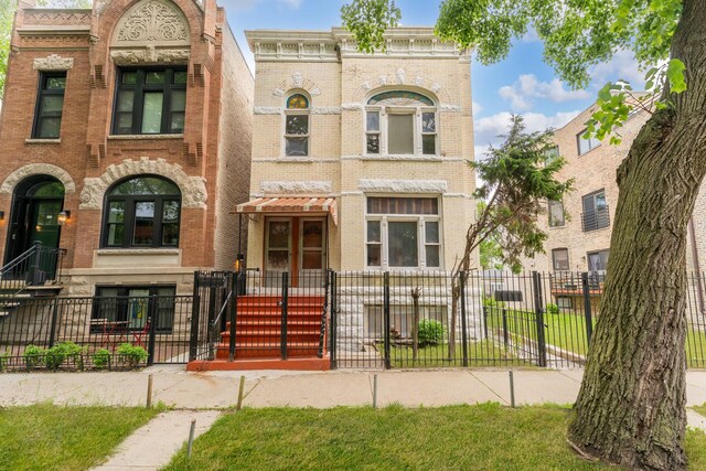 1351 N Campbell Ave, Chicago, IL 60622 - view of front of property featuring brick siding and a fenced front yard