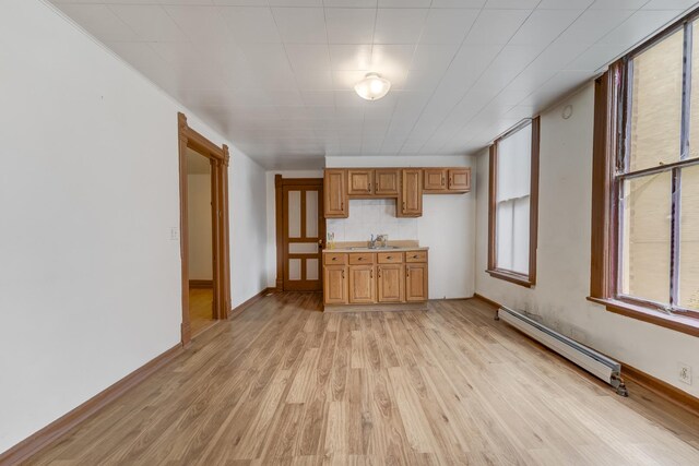 1351 N Campbell Ave, Chicago, IL 60622 - unfurnished living room featuring a baseboard heating unit, a sink, light wood finished floors, and baseboards
