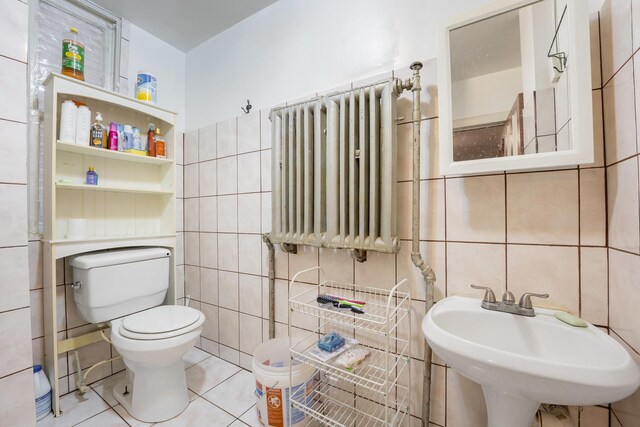 1351 N Campbell Ave, Chicago, IL 60622 - bathroom with tile walls, a sink, radiator, toilet, and tile patterned floors