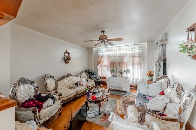 living room with ceiling fan and hardwood / wood-style floors