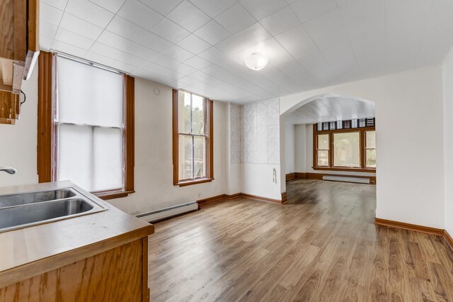 1351 N Campbell Ave, Chicago, IL 60622 - kitchen featuring a sink, baseboard heating, arched walkways, and wood finished floors