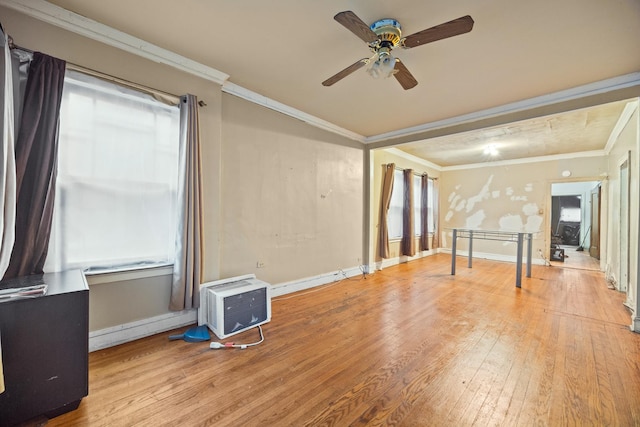 empty room with ceiling fan, ornamental molding, and light hardwood / wood-style flooring