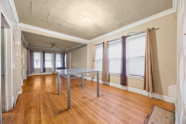 game room featuring light wood-type flooring, ceiling fan, and crown molding