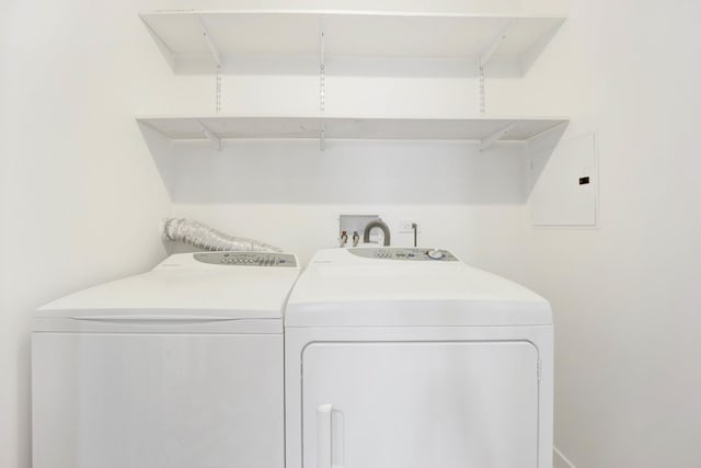 clothes washing area with electric panel and washing machine and clothes dryer