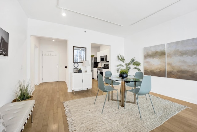 dining space with light wood-type flooring