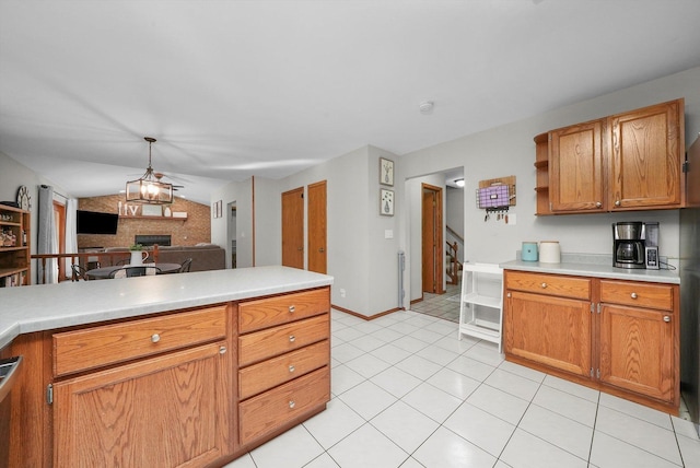 kitchen with ceiling fan, light tile patterned floors, pendant lighting, and vaulted ceiling