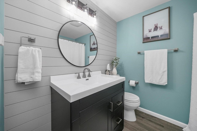 bathroom with vanity, wood-type flooring, and toilet