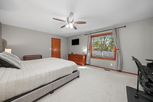 bedroom with ceiling fan and light colored carpet