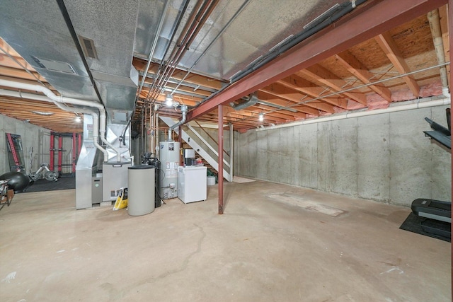 basement with washer / dryer, gas water heater, and heating unit