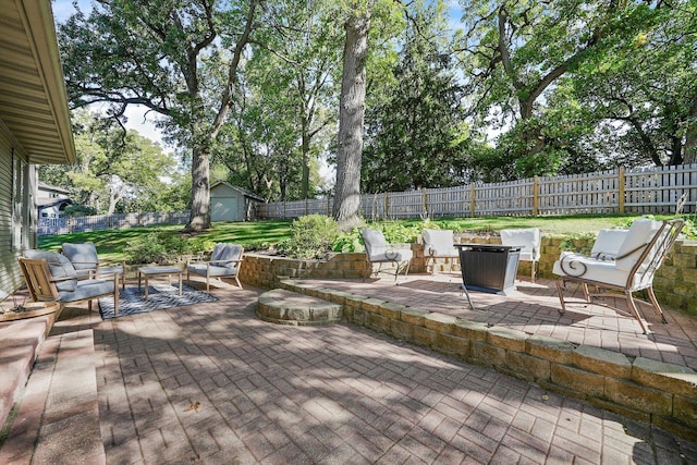 view of patio featuring an outdoor living space and a shed