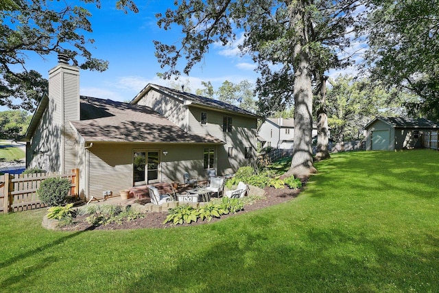 back of property featuring a yard, a patio, and a storage shed