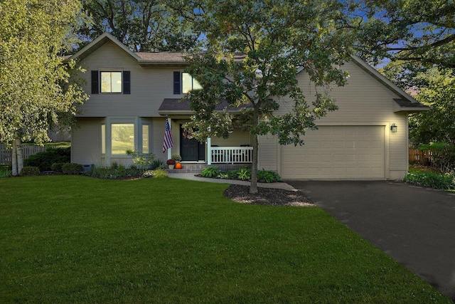 front facade with covered porch, a front yard, and a garage