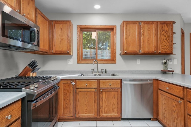 kitchen featuring light tile patterned floors, sink, and appliances with stainless steel finishes