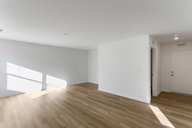 spare room featuring wood-type flooring