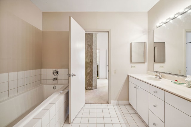 bathroom featuring tile patterned floors, baseboards, a bath, and vanity