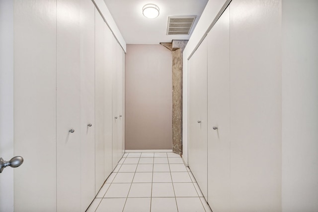 hallway with light tile patterned flooring and visible vents