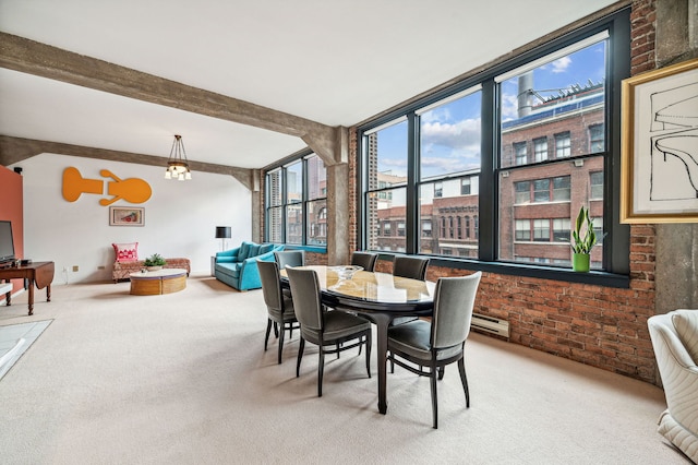 dining room with baseboard heating, light carpet, beamed ceiling, and brick wall