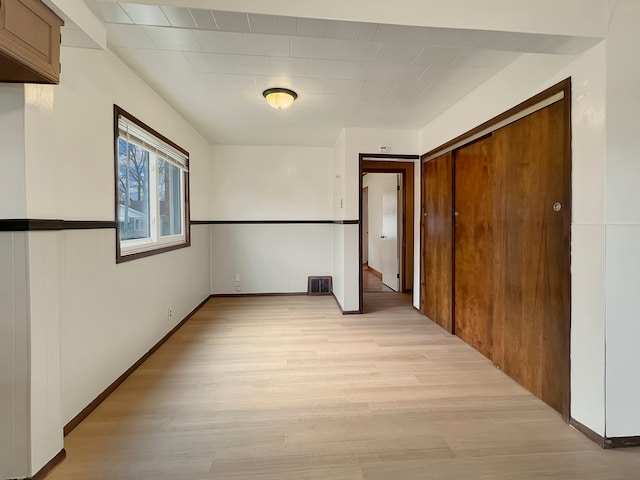 interior space with a closet and light hardwood / wood-style flooring