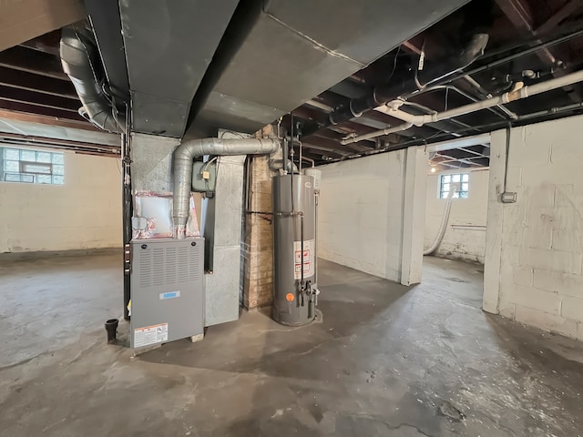 basement featuring heating unit and gas water heater