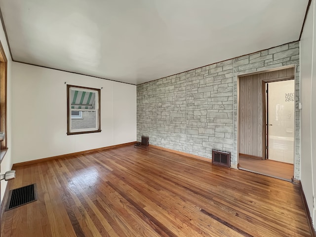 unfurnished room featuring hardwood / wood-style flooring