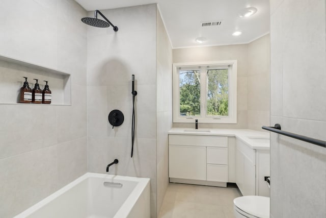 full bathroom featuring tiled shower / bath combo, tile patterned floors, toilet, vanity, and ornamental molding