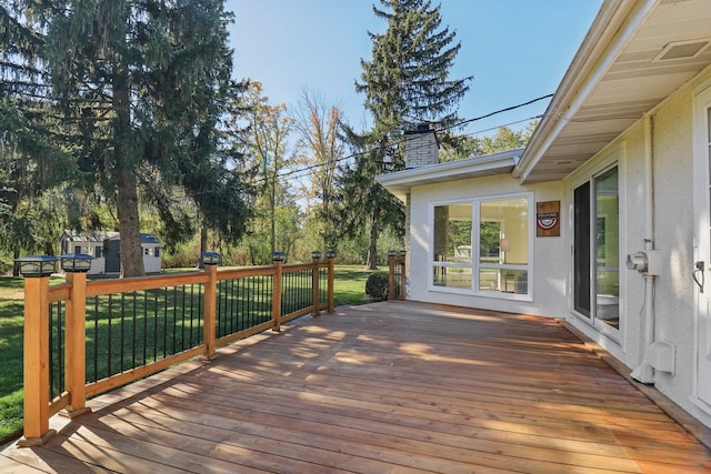 wooden terrace with a lawn