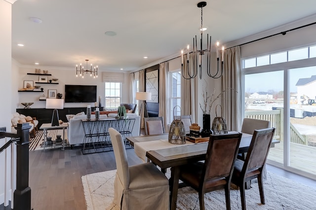 dining room featuring hardwood / wood-style flooring, a notable chandelier, and ornamental molding