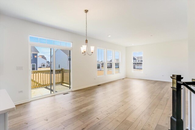 living room with crown molding and an inviting chandelier