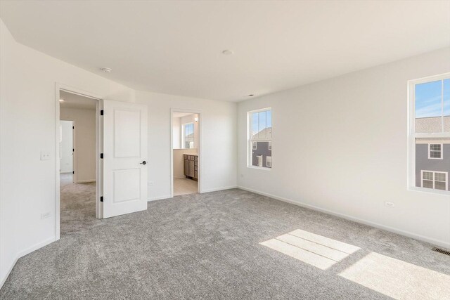 carpeted bedroom with connected bathroom, crown molding, vaulted ceiling, and a notable chandelier