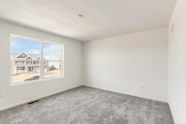 carpeted bedroom featuring a nursery area and crown molding