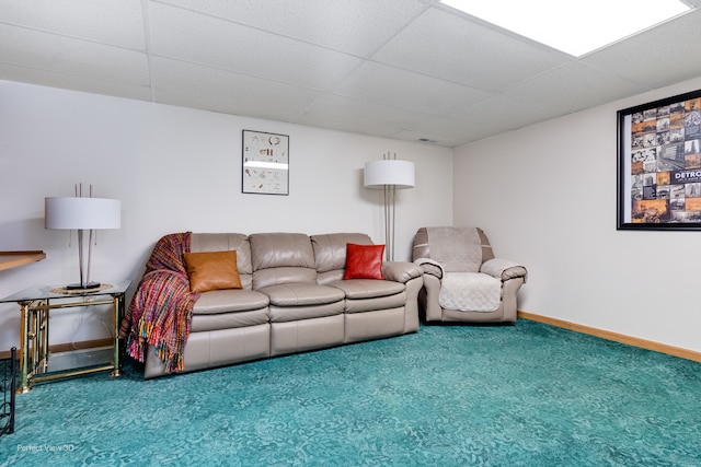 carpeted living room with a paneled ceiling