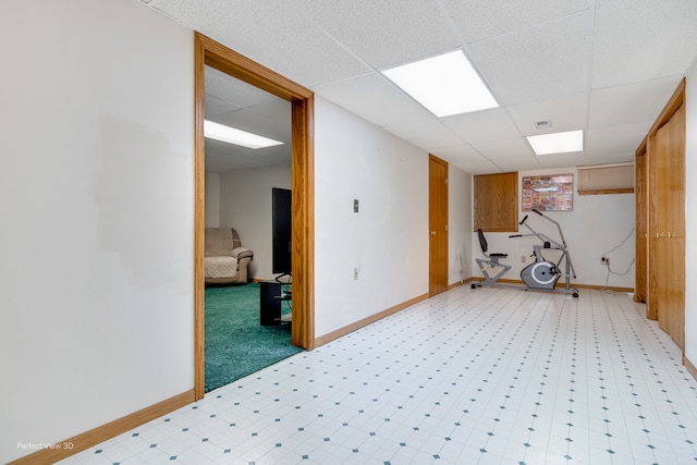 interior space with a paneled ceiling