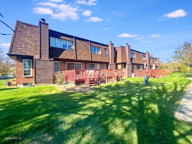 back of property featuring a deck and a yard